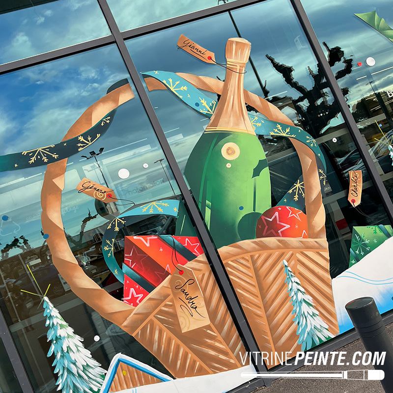 Panier geant avec Bouteille de champagne géante et flûte de champagne XXL peintes sur vitrine, idée de décoration festive et élégante pour magasin.